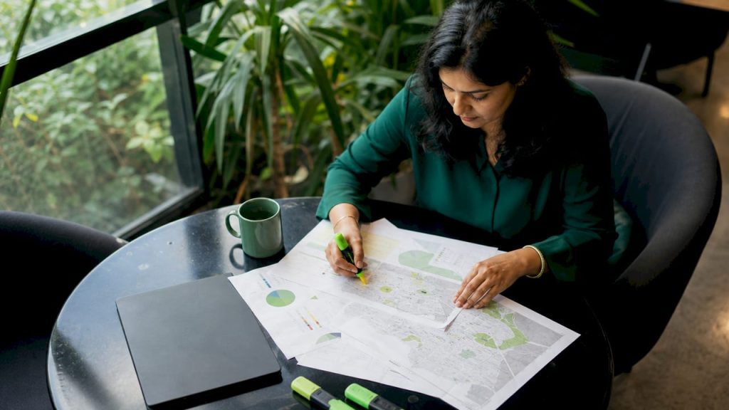 Marketing specialist reviewing local outreach maps